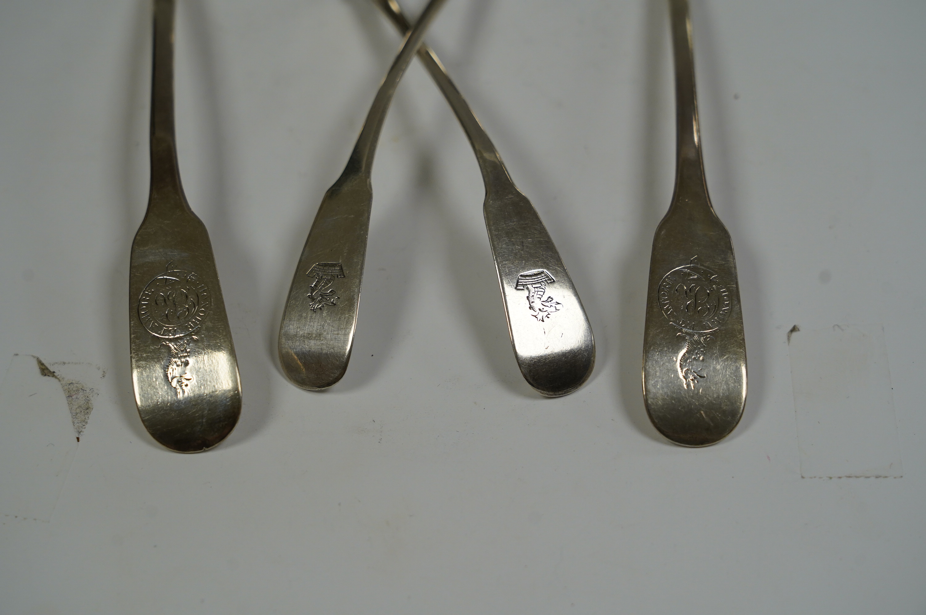 A pair of George IV Scottish silver fiddle pattern sauce ladles, Andrew Wilkie, Edinburgh, 1824, 15.2cm, together with a similar Irish pair by Richard Garde and another maker's mark RT, Dublin, 1823, 4.7oz. Condition - f